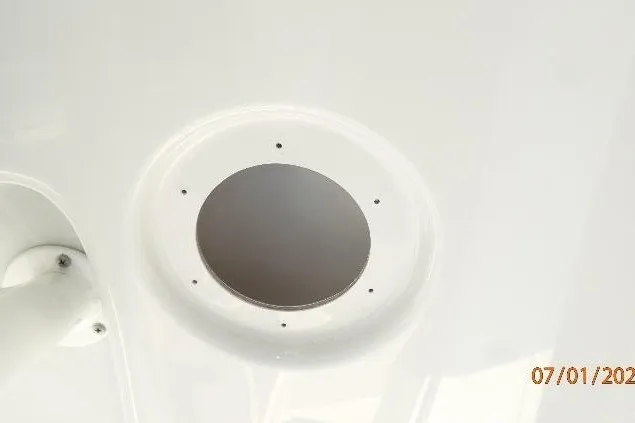 Slide: The Image of 2023 Cape Horn 34XS boat detail, featuring a circular hatch on a white surface. - 45