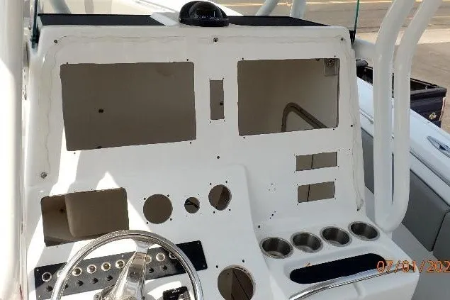 Slide: The Image of Console of 2023 Cape Horn 34XS boat with steering wheel and cup holders. - 38
