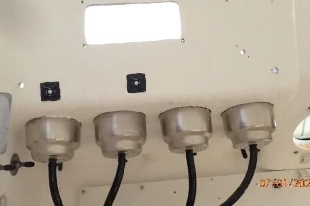 Slide: The Image of Four metal fixtures with black cables on a 2023 Cape Horn 34XS boat interior. - 52