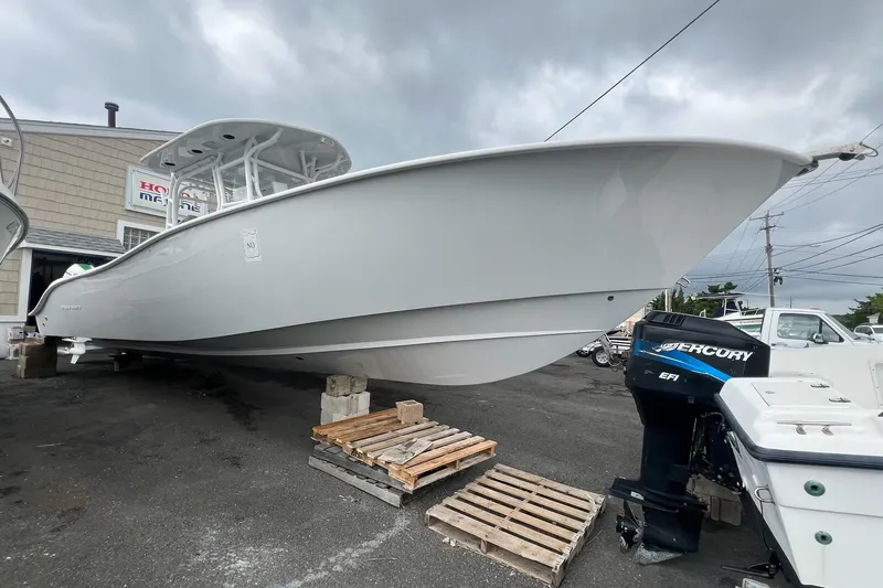The Image of 2023 Cape Horn 34XS boat displayed outdoors with Mercury engine. - 1