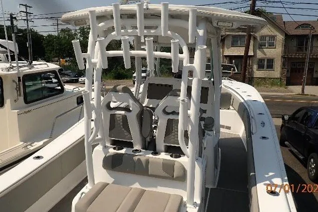 Slide: The Image of 2023 Cape Horn 34XS boat with seating and rod holders, docked outdoors. - 25