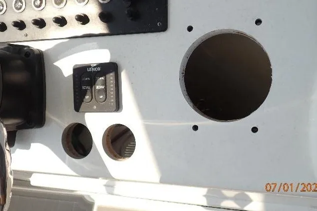 Slide: The Image of Control panel of 2023 Cape Horn 34XS boat with circular cutouts and switches. - 40