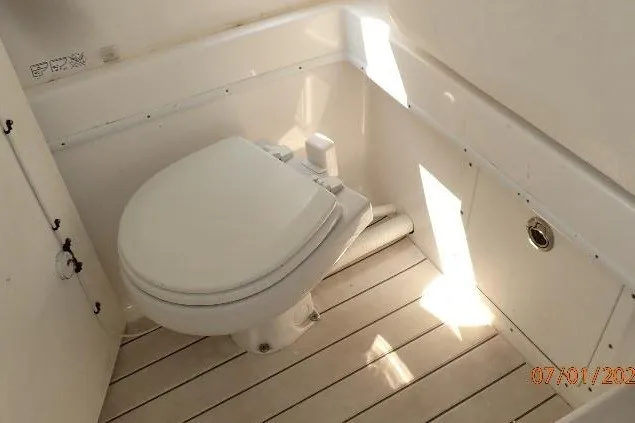 Slide: The Image of 2023 Cape Horn 34XS boat interior with a white marine toilet. - 49