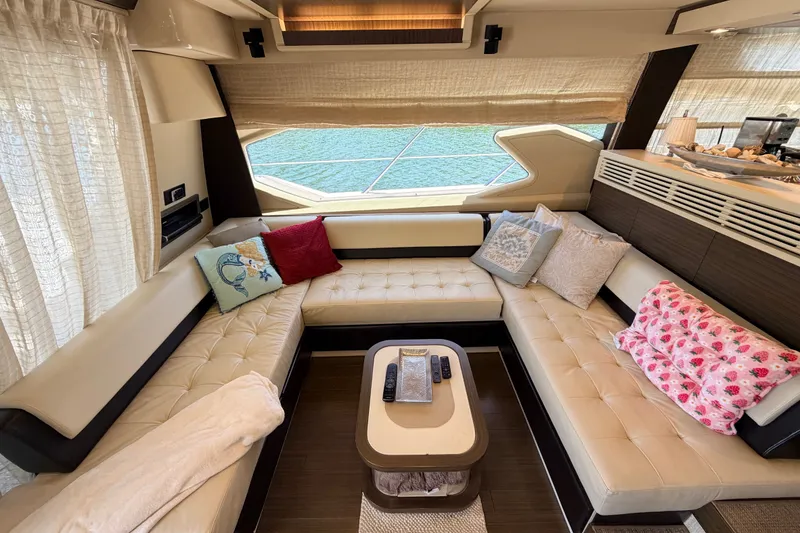 Slide: The Image of Luxurious 2014 Azimut 64 yacht interior with elegant seating and decorative pillows. - 13
