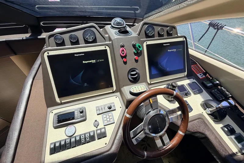 Slide: The Image of Cockpit of 2014 Azimut 64 yacht with dual Raymarine displays and leather steering wheel. - 26