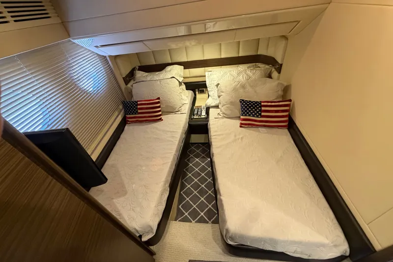Slide: The Image of Luxurious twin cabin in 2014 Azimut 64 yacht with American flag pillows. - 38