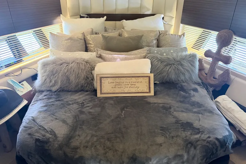 Slide: The Image of Luxurious bedroom interior on a 2014 Azimut 64 yacht, featuring plush pillows and cozy decor. - 36