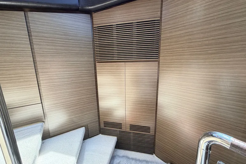 Slide: The Image of Interior of 2014 Azimut 64 yacht with modern wood paneling and carpeted stairs. - 24