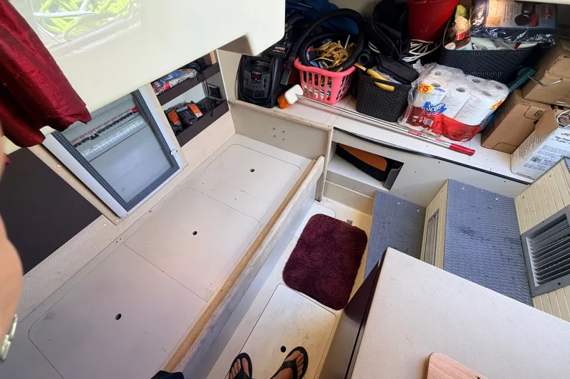 Slide: The Image of Interior storage area of a 2014 Azimut 64 yacht, featuring organized supplies and equipment. - 54