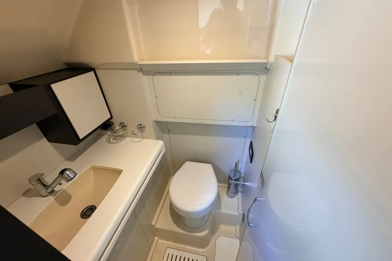 Slide: The Image of Compact bathroom on 2014 Azimut 64 yacht with sink, toilet, and storage. - 55