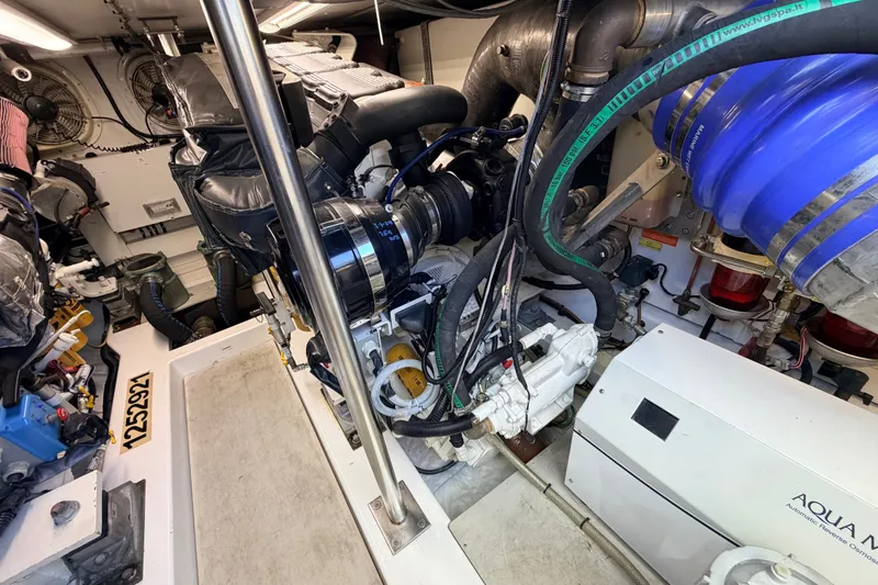 Slide: The Image of Engine room of a 2014 Azimut 64 yacht, showcasing mechanical components and systems. - 48