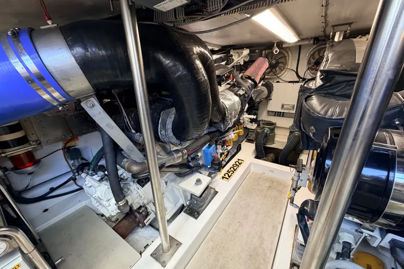 Slide: The Image of Engine room of a 2014 Azimut 64 yacht, showcasing mechanical components and piping. - 49