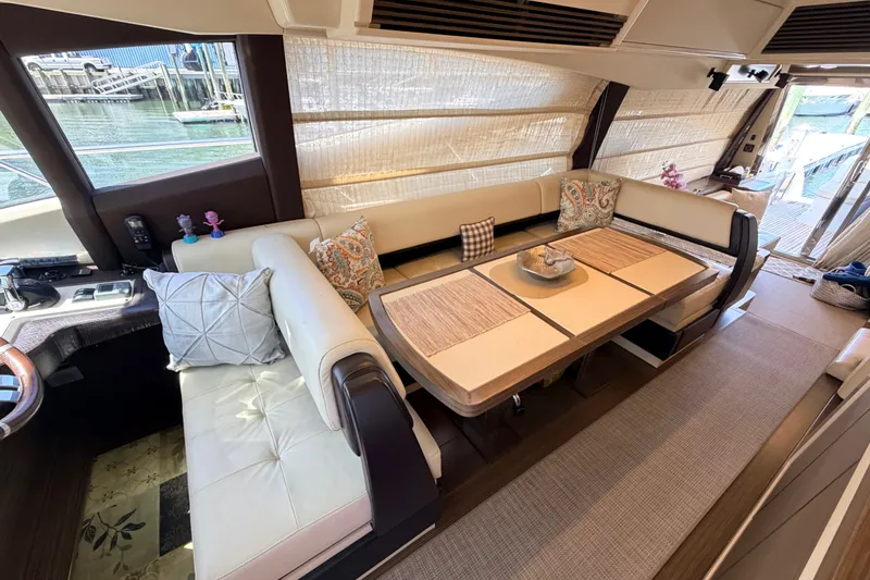 Slide: The Image of Luxurious interior of a 2014 Azimut 64 yacht with elegant seating and dining area. - 15