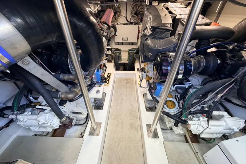 Slide: The Image of Engine room of a 2014 Azimut 64 yacht, showcasing dual engines and mechanical components. - 47