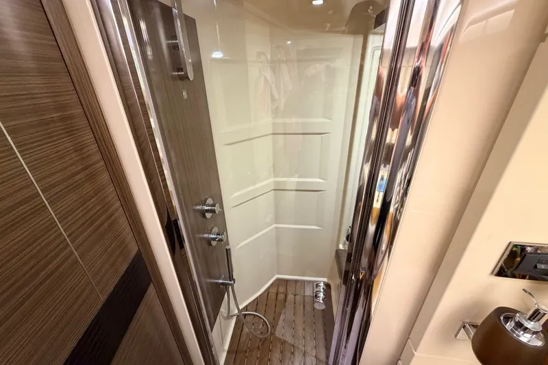 Slide: The Image of Luxurious shower area in a 2014 Azimut 64 yacht, featuring modern fixtures and wood accents. - 35