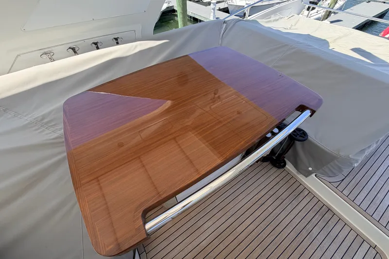 Slide: The Image of Polished wooden table on 2014 Azimut 64 yacht deck, surrounded by beige upholstery. - 45