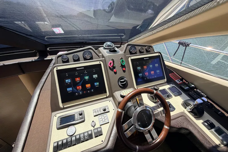 Slide: The Image of Cockpit of 2014 Azimut 64 yacht with dual touchscreens and modern navigation controls. - 27