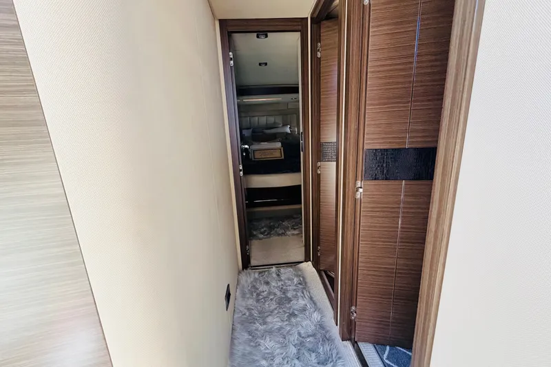 Slide: The Image of Hallway inside 2014 Azimut 64 yacht with wooden doors and plush carpet. - 25