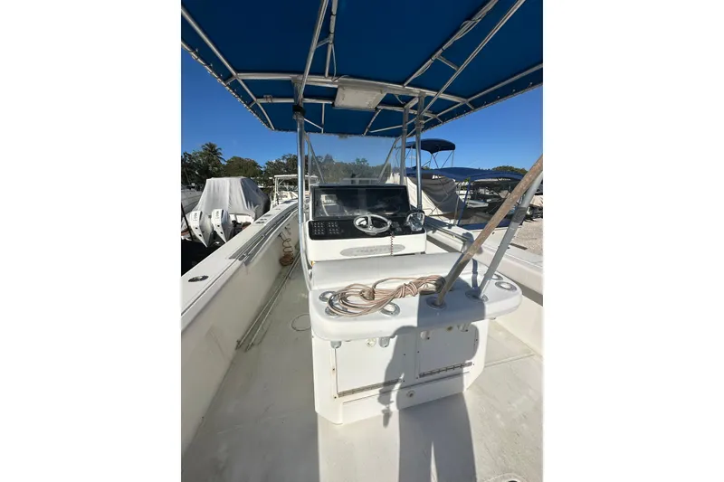 Slide: The Image of 2000 SeaCraft SC 32 Master Angler boat with blue canopy and steering console. - 2