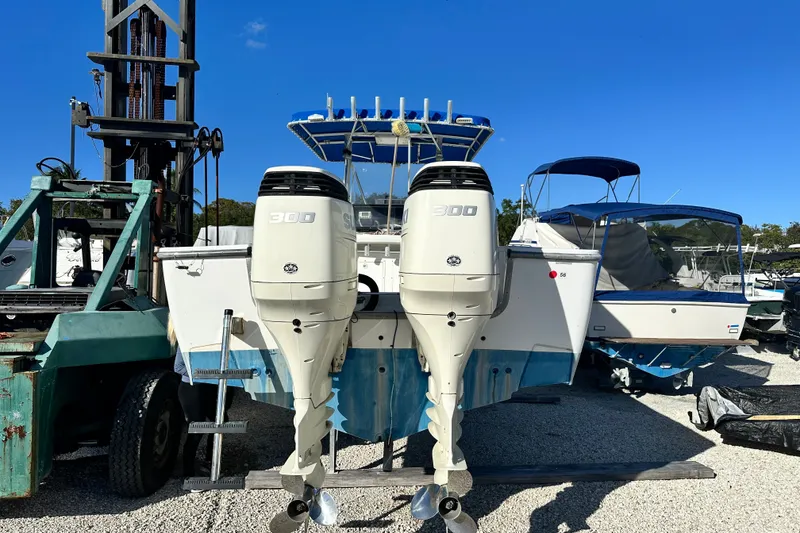 Slide: The Image of 2000 SeaCraft SC 32 Master Angler boat with dual 300 horsepower engines, docked outdoors. - 3