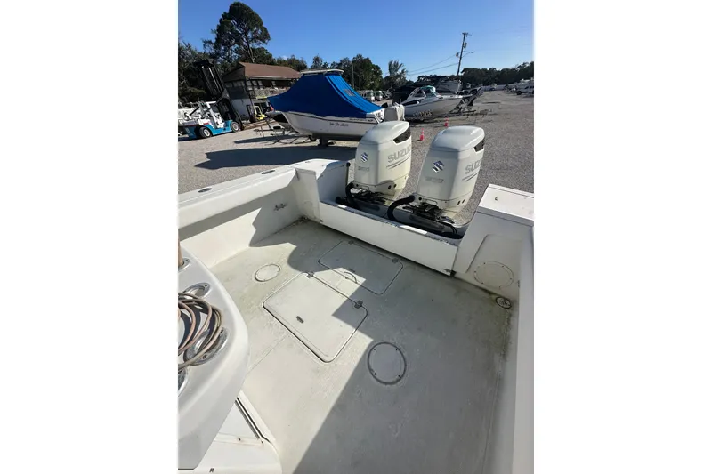 Slide: The Image of 2000 SeaCraft SC 32 Master Angler boat with twin Suzuki outboard motors in a marina. - 4