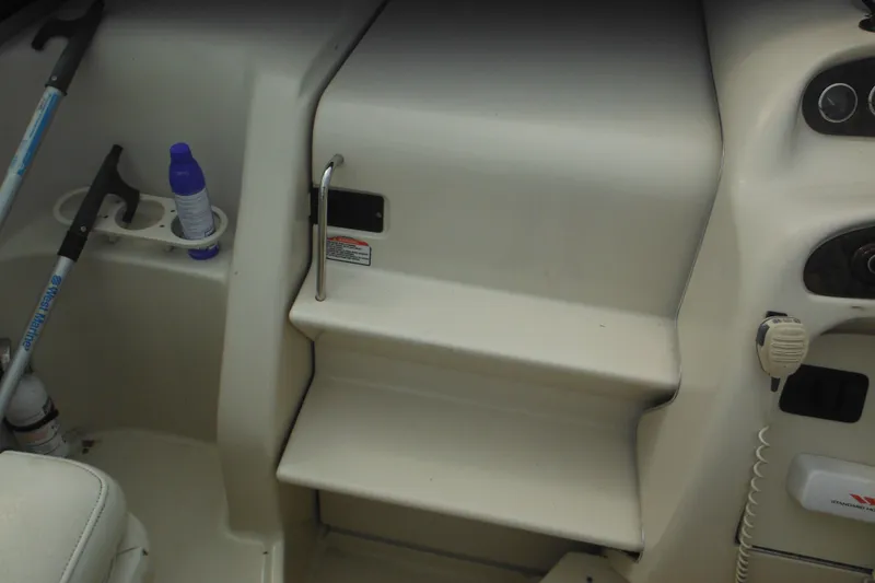 Slide: The Image of 2004 Sea Ray 245 Weekender boat interior with steps and storage compartments. - 27