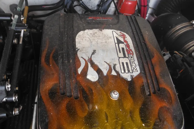 Slide: The Image of Engine of a 2004 Sea Ray 245 Weekender with flame design and 357 Mag Bravo label. - 36