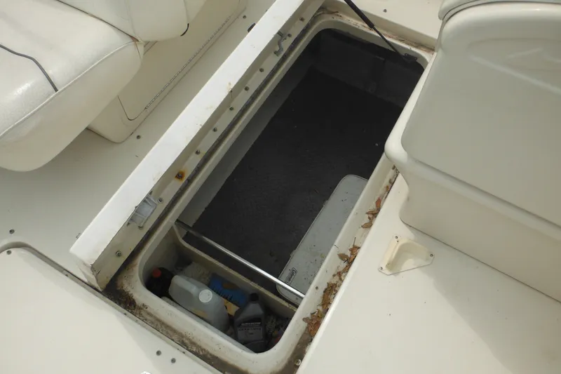 Slide: The Image of Storage compartment on a 2004 Sea Ray 245 Weekender boat, showing interior details. - 26