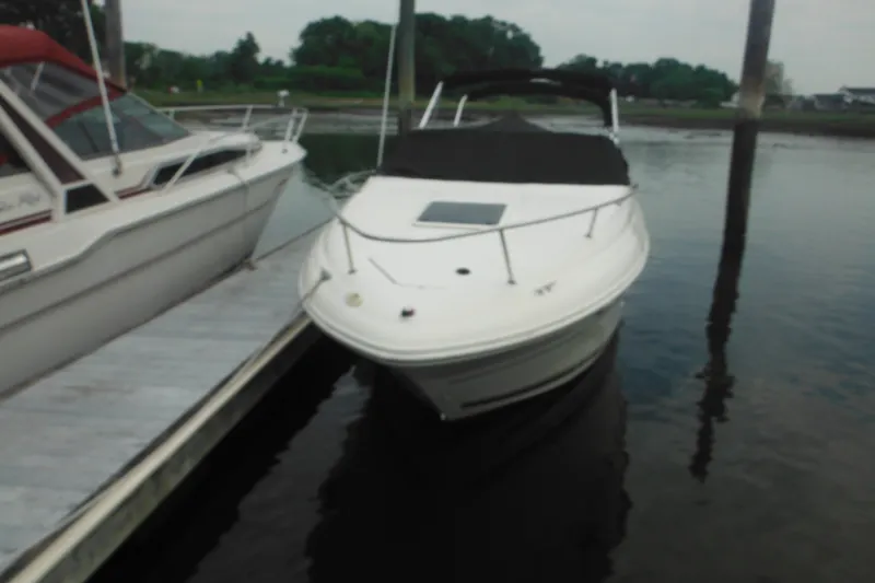 Slide: The Image of 2004 Sea Ray 245 Weekender boat docked on calm water. - 13