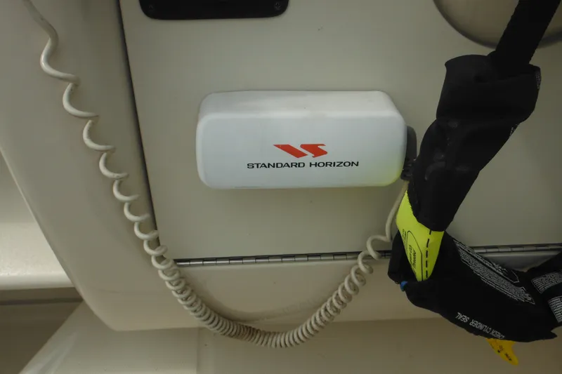 Slide: The Image of Standard Horizon radio on 2004 Sea Ray 245 Weekender boat dashboard. - 25