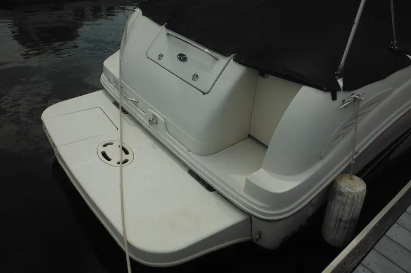 Slide: The Image of 2004 Sea Ray 245 Weekender boat with covered deck and swim platform. - 15