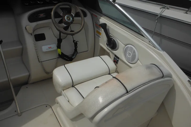 Slide: The Image of Interior of 2004 Sea Ray 245 Weekender boat showing steering wheel and seating area. - 20
