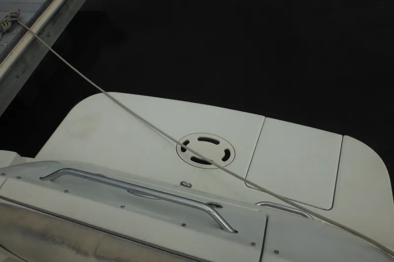 Slide: The Image of 2004 Sea Ray 245 Weekender boat stern view with dock line attached. - 29