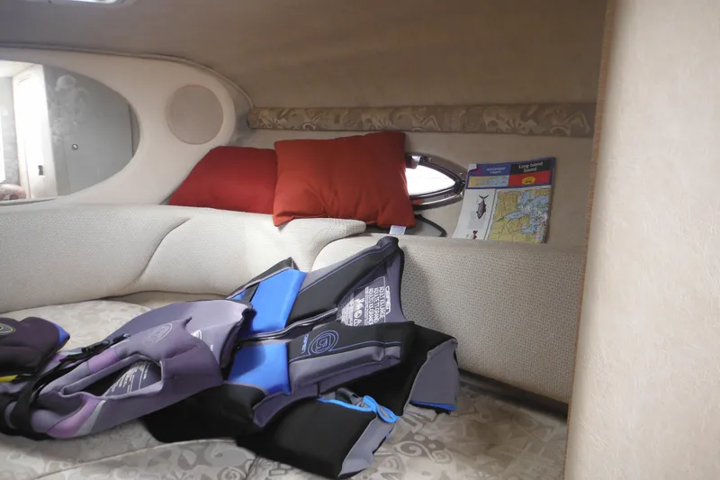 Slide: The Image of Interior of 2004 Sea Ray 245 Weekender with life jackets and maps. - 40