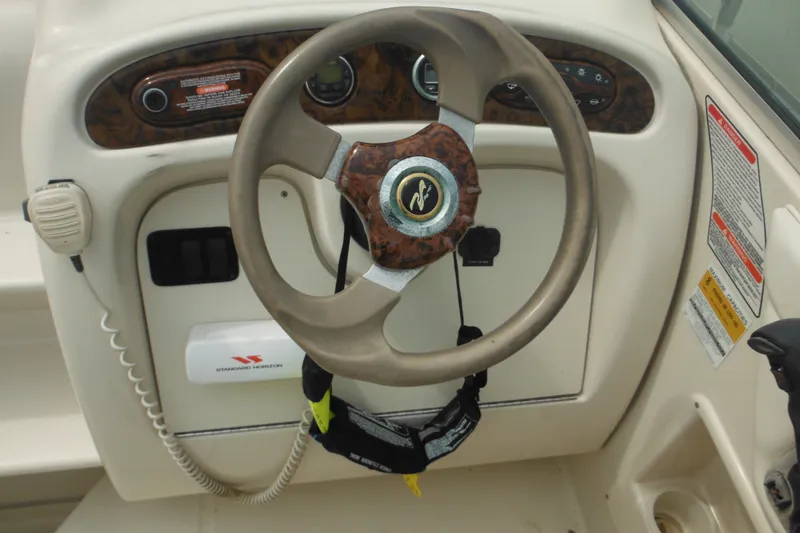 Slide: The Image of Steering wheel and dashboard of 2004 Sea Ray 245 Weekender boat. - 24