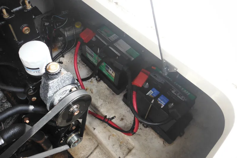 Slide: The Image of Engine compartment of 2004 Sea Ray 245 Weekender with batteries and components visible. - 34