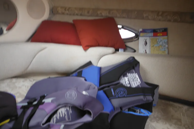 Slide: The Image of Interior of 2004 Sea Ray 245 Weekender with life jackets and nautical chart. - 51