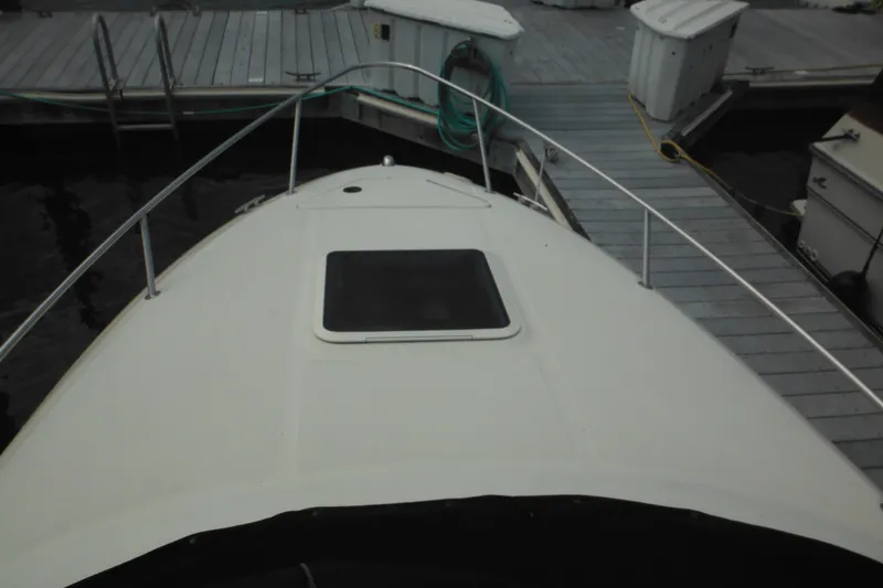 Slide: The Image of 2004 Sea Ray 245 Weekender boat docked at marina, view from bow. - 53