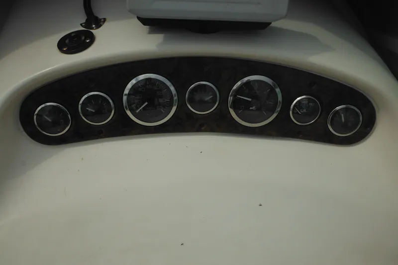 Slide: The Image of Dashboard of a 2004 Sea Ray 245 Weekender boat with multiple gauges. - 23