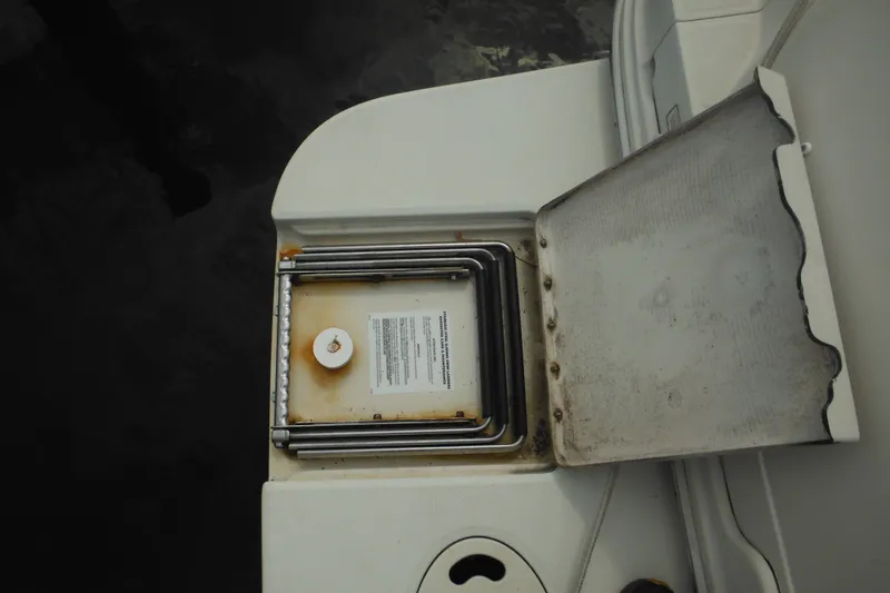 Slide: The Image of 2004 Sea Ray 245 Weekender boat grill with open lid, showing cooking surface. - 31