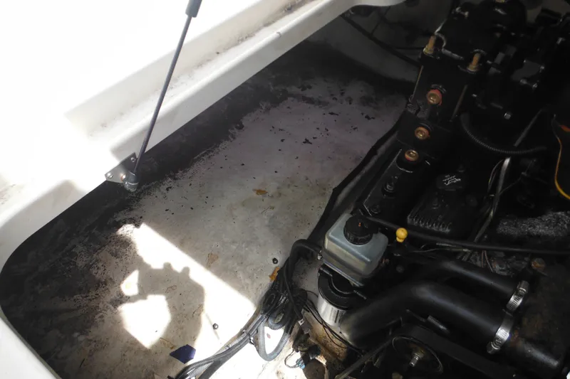Slide: The Image of Engine compartment of a 2004 Sea Ray 245 Weekender boat, showing mechanical components. - 35