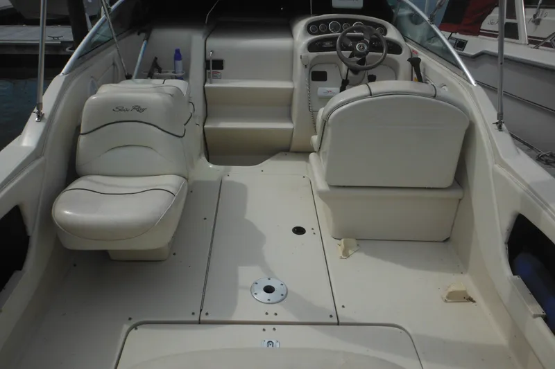 Slide: The Image of 2004 Sea Ray 245 Weekender boat interior with seating and steering console. - 32