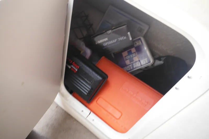 Slide: The Image of Storage compartment in a 2004 Sea Ray 245 Weekender boat with safety equipment. - 42