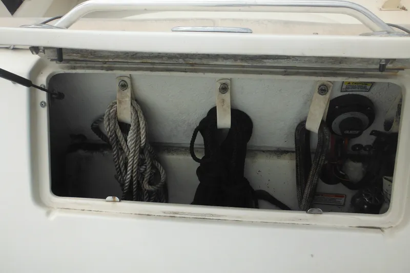 Slide: The Image of Storage compartment with ropes on a 2004 Sea Ray 245 Weekender boat. - 30