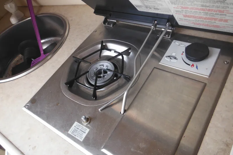 Slide: The Image of Stainless steel stove and sink in 2004 Sea Ray 245 Weekender boat kitchen. - 43