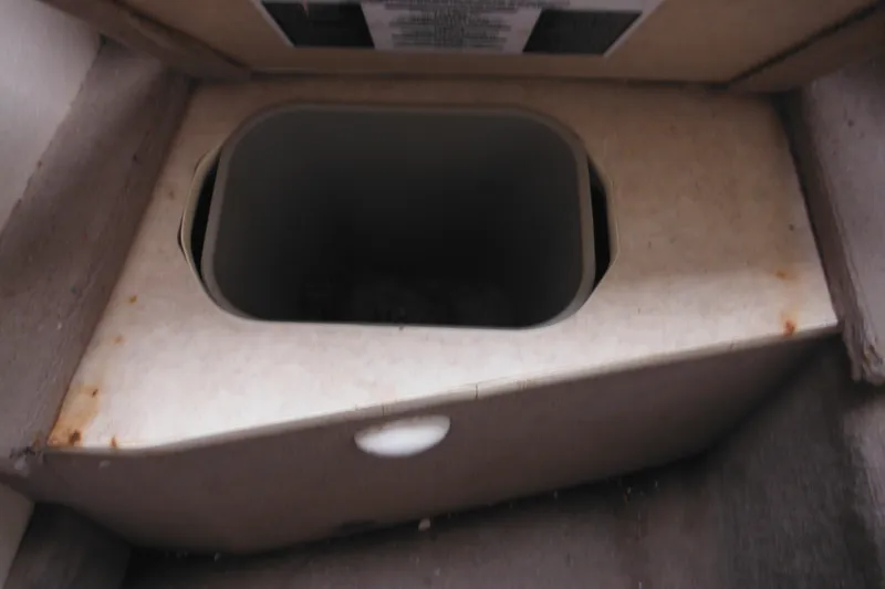 Slide: The Image of Storage compartment inside a 2004 Sea Ray 245 Weekender boat. - 48
