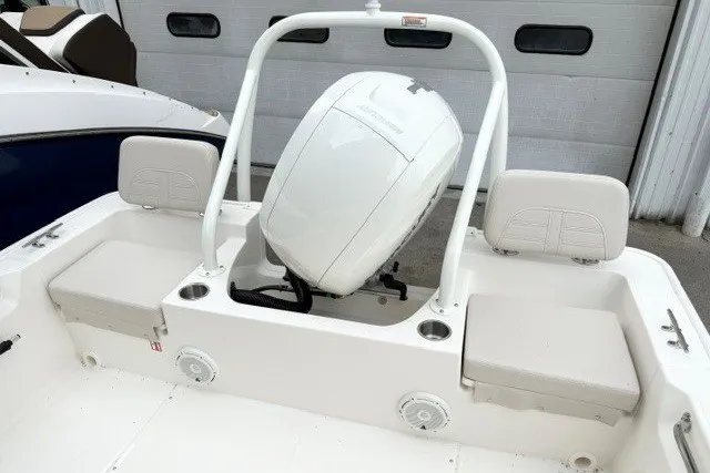 Slide: The Image of 2027 Boston Whaler 190 Montauk boat interior with engine and seating. - 6