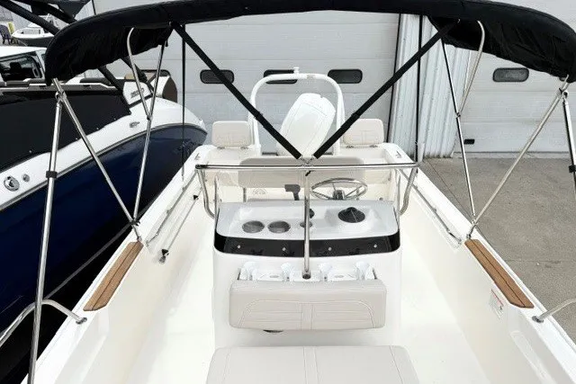 Slide: The Image of 2027 Boston Whaler 190 Montauk boat interior with steering console and canopy. - 4