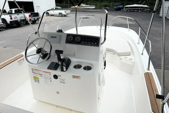 Slide: The Image of 2027 Boston Whaler 190 Montauk boat interior with steering console and seating area. - 5