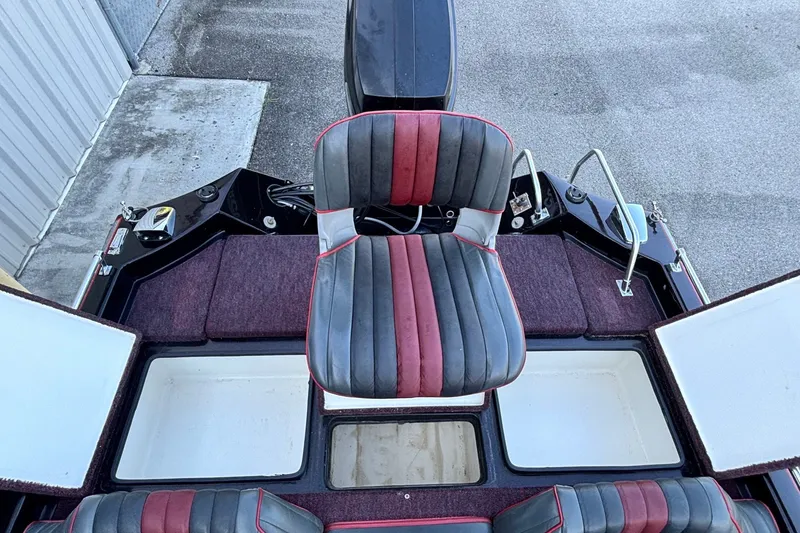 Slide: The Image of 1988 Ranger 375V boat interior with striped seating and storage compartments. - 11